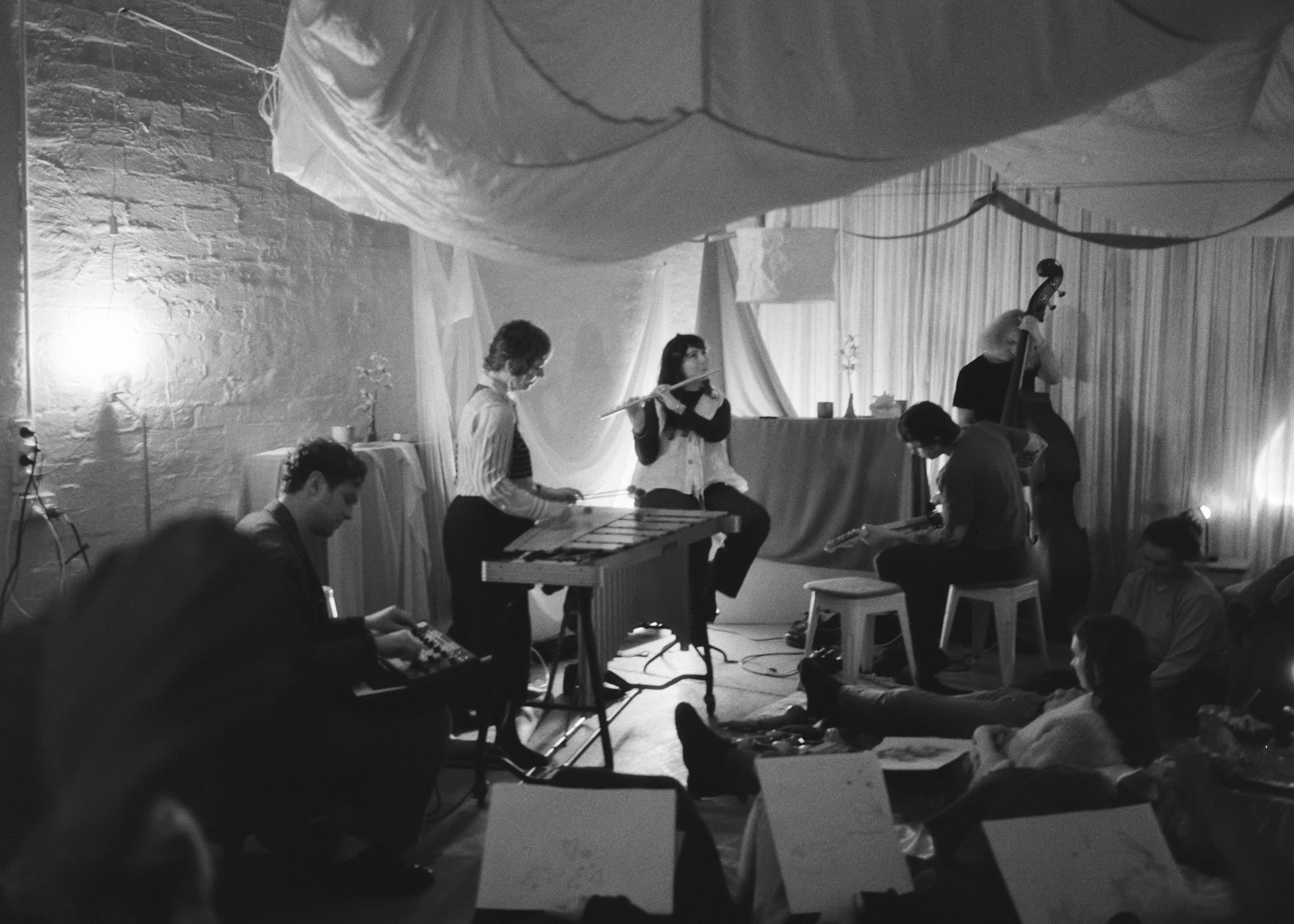 A gathering of people in a room, immersed in music